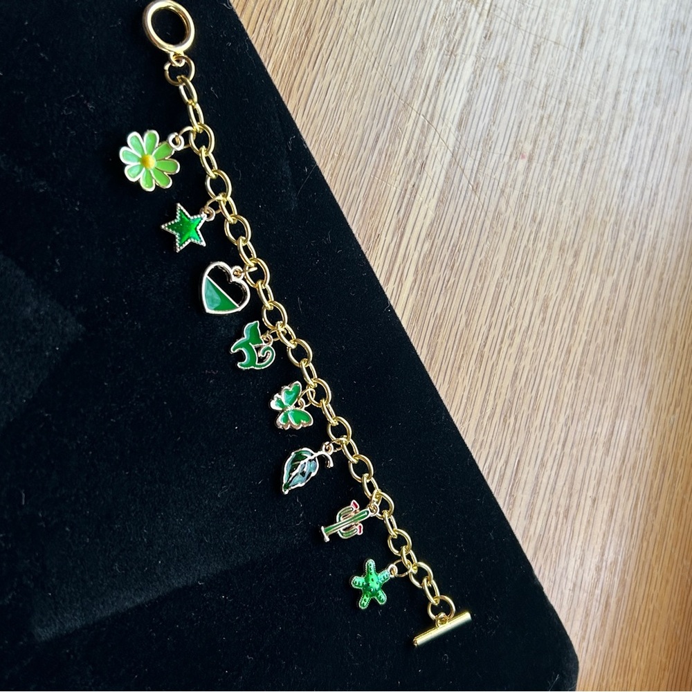 Gold toned, green themed Charm Bracelet